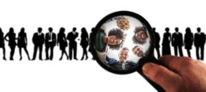 A magnifying glass over people.