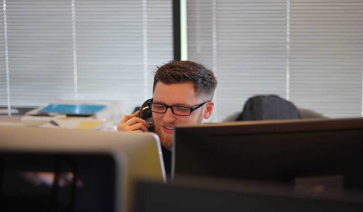 A man working the phones for a company.