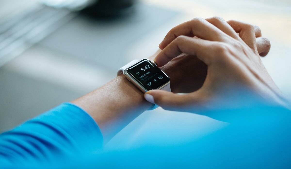 A person setting a fitness watch.